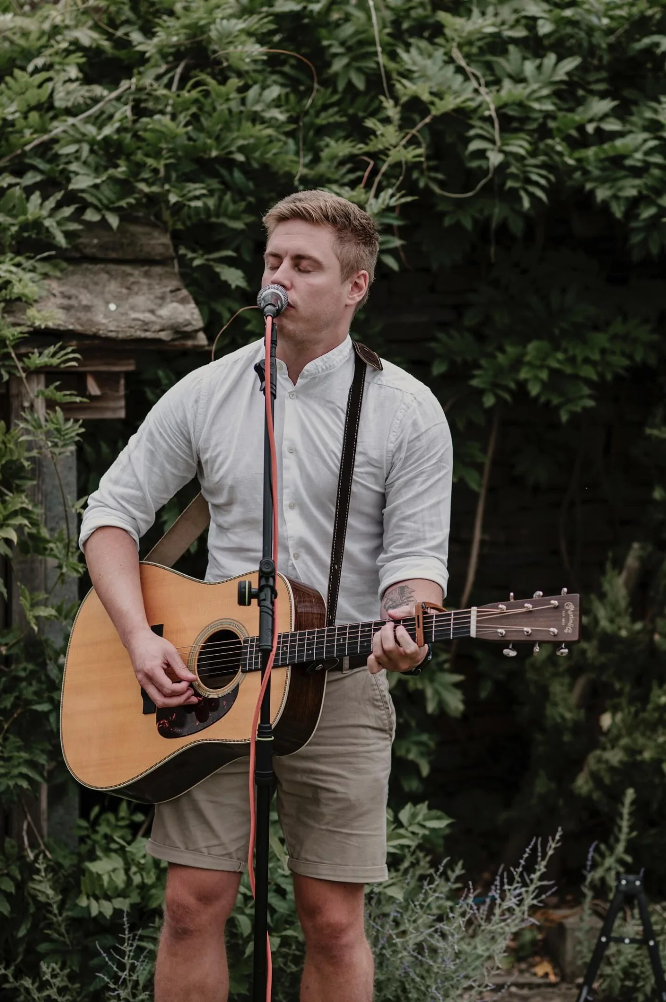 Jake performing acoustic music at a wedding